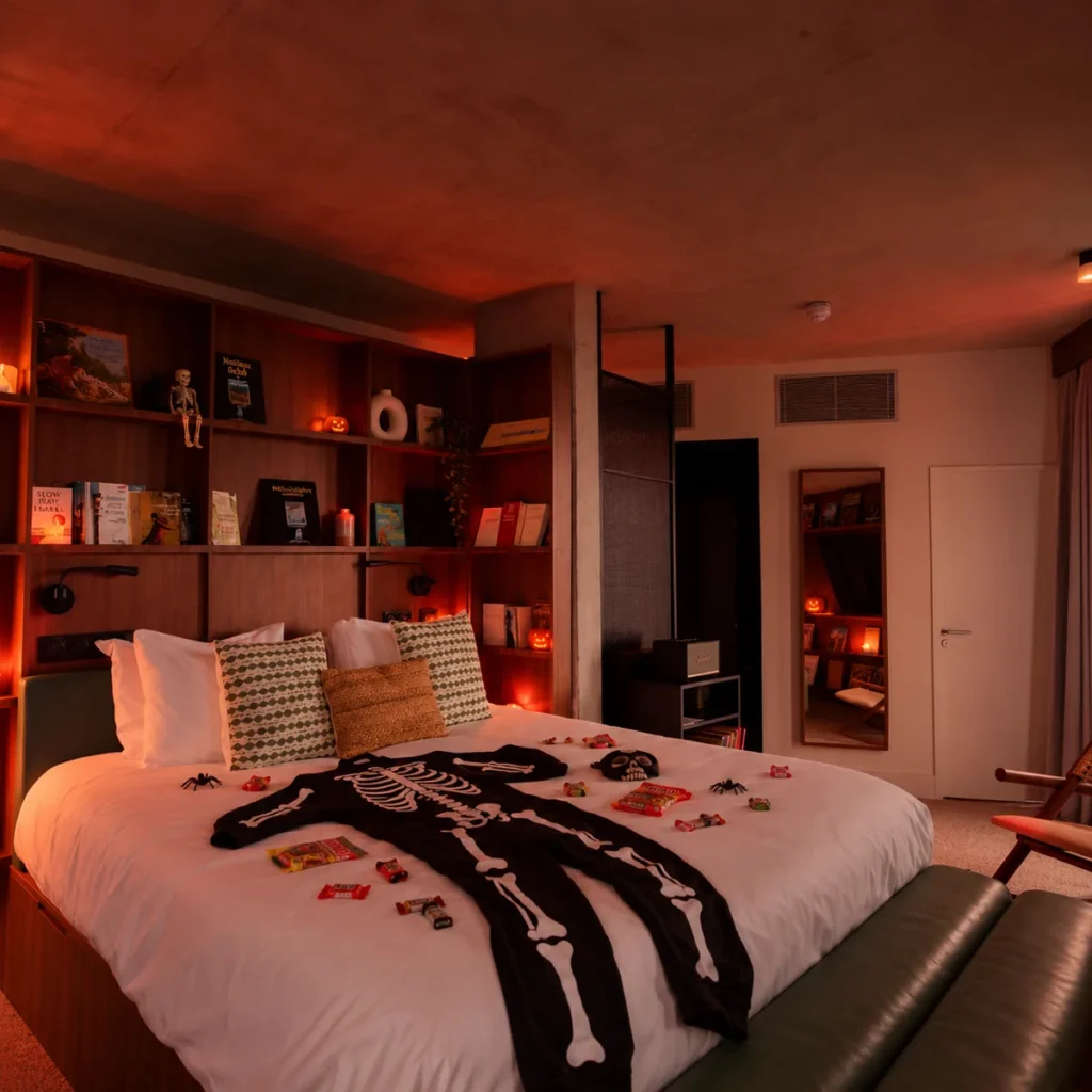 Chambre de l'hôtel JOST Bordeaux décorée pour Halloween, pyjama squelette et bonbons sur le lit